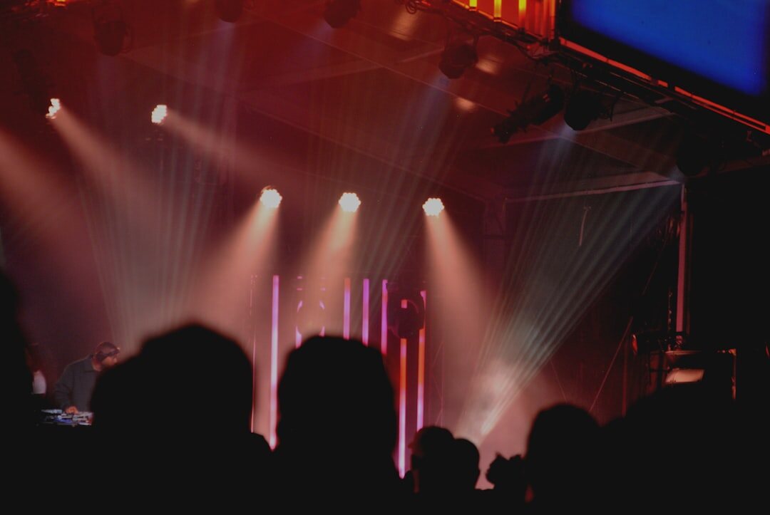 Crowd and bright stage lights at a live entertainment event