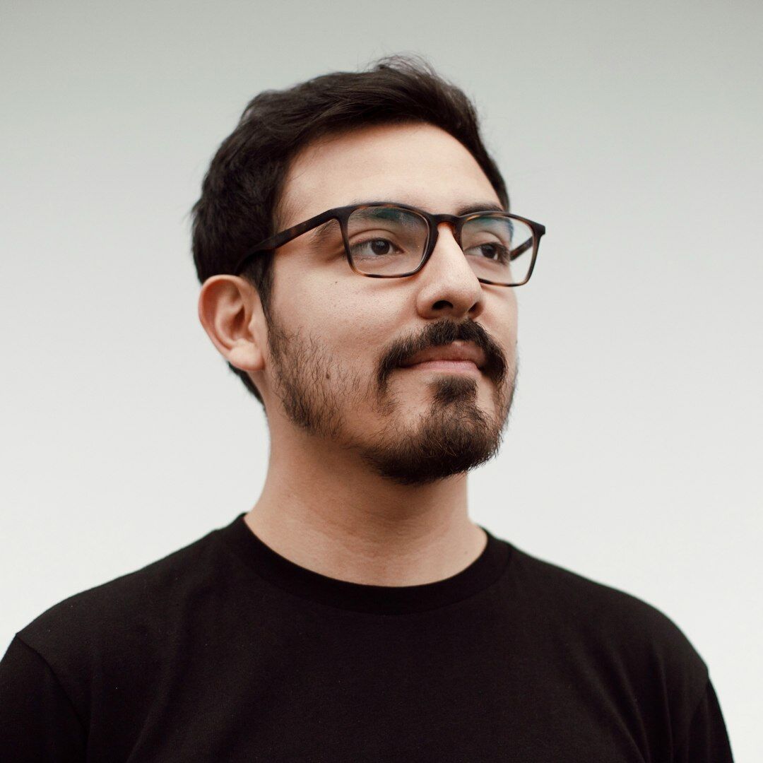Studio portrait of a Latino male editor in chief